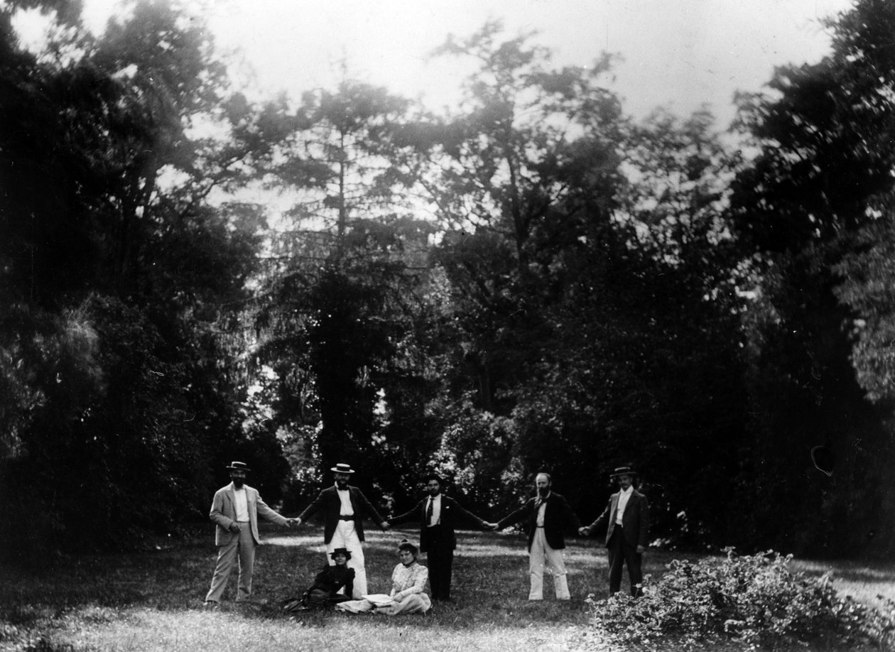 Group of friends holding hands in the garden of Le Relais, home of the Natanson family in Villeneuve-sur-Yonne, c. 1899 by French Photographer