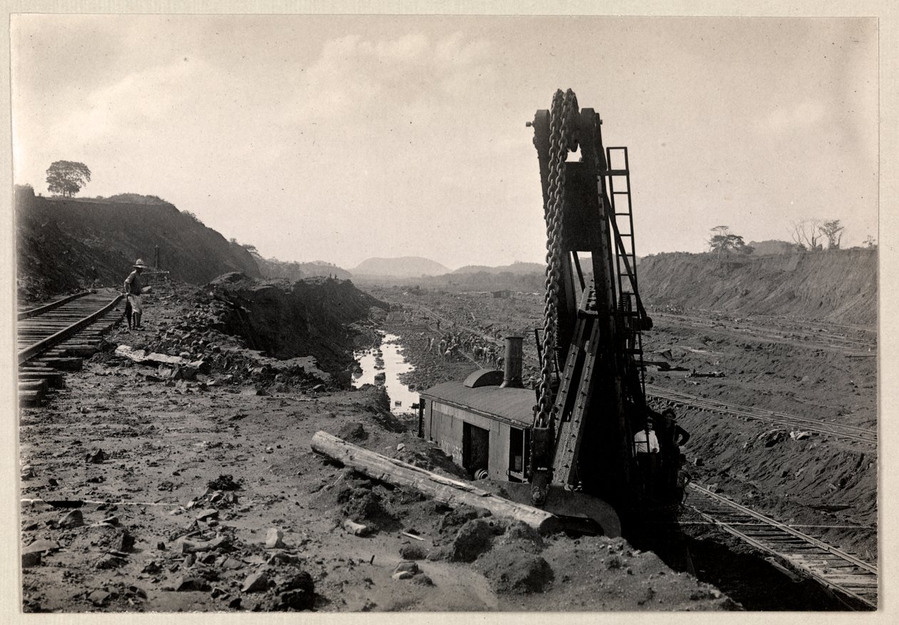 View of laborers digging the Panama Canal with railroad tracks and digging machine, 1912 or 1913 by Byron Company