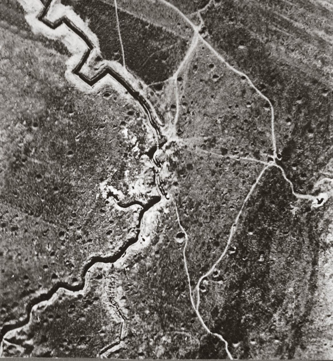 Over the German lines, showing deep trenches, mine craters and shell-pitted ground by English Photographer