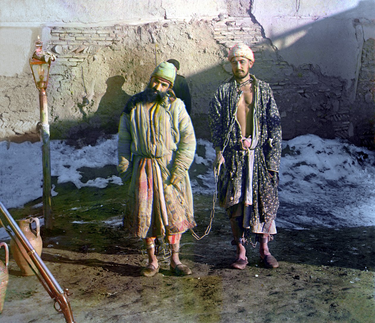 Two prisoners in shackles and a guard behind them, Russian Empire by Sergey Prokudin Gorsky