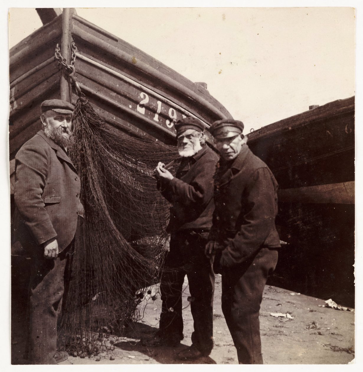 Fishermen standing by a net, c 1905 by Unbekannt
