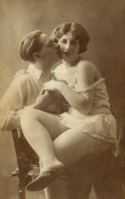 Man Kissing Woman on Cheek by English Photographer