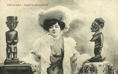 Woman with African statuettes by French Photographer